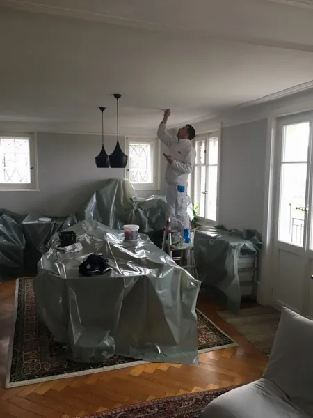 Pièce de vie couverte de bâches avant que la peinture commence